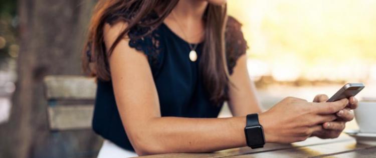 Woman sitting at table texting